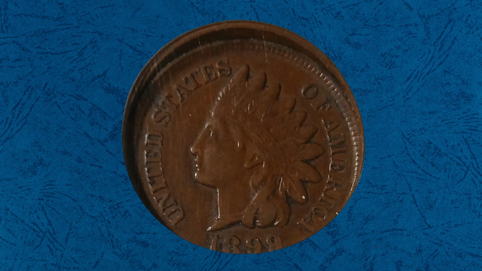 1899 Indian Head penny off-center strike error showing the design shifted to one side with a blank crescent area