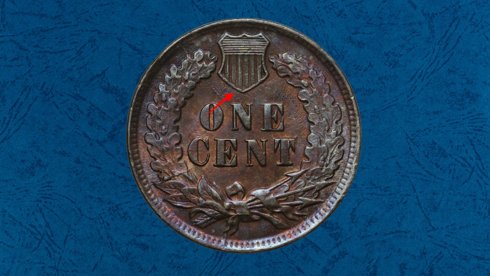 1899 Indian Head penny die crack or cud error showing a raised line or blob of metal on the coin surface